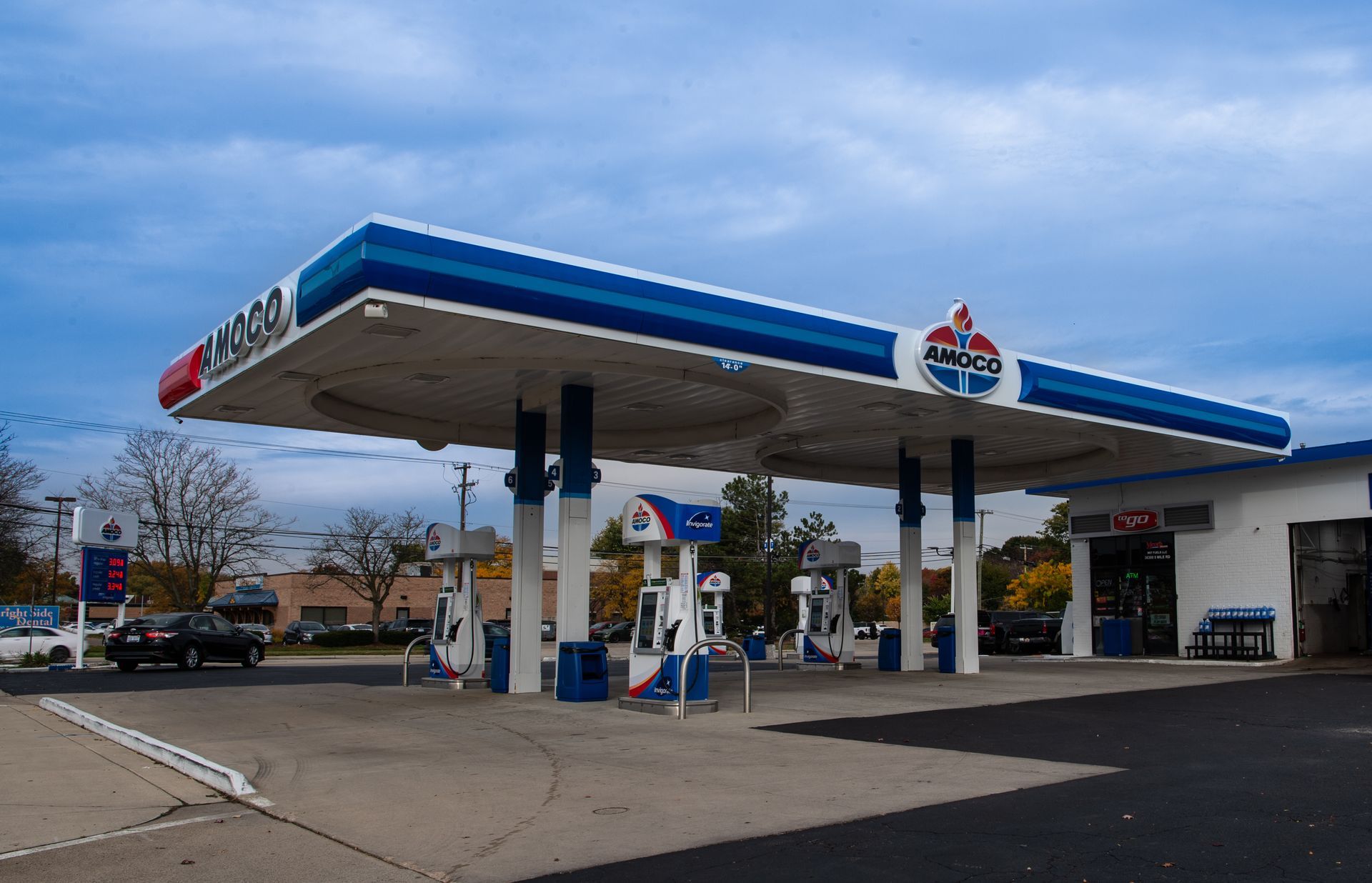 A gas station with a blue and white roof