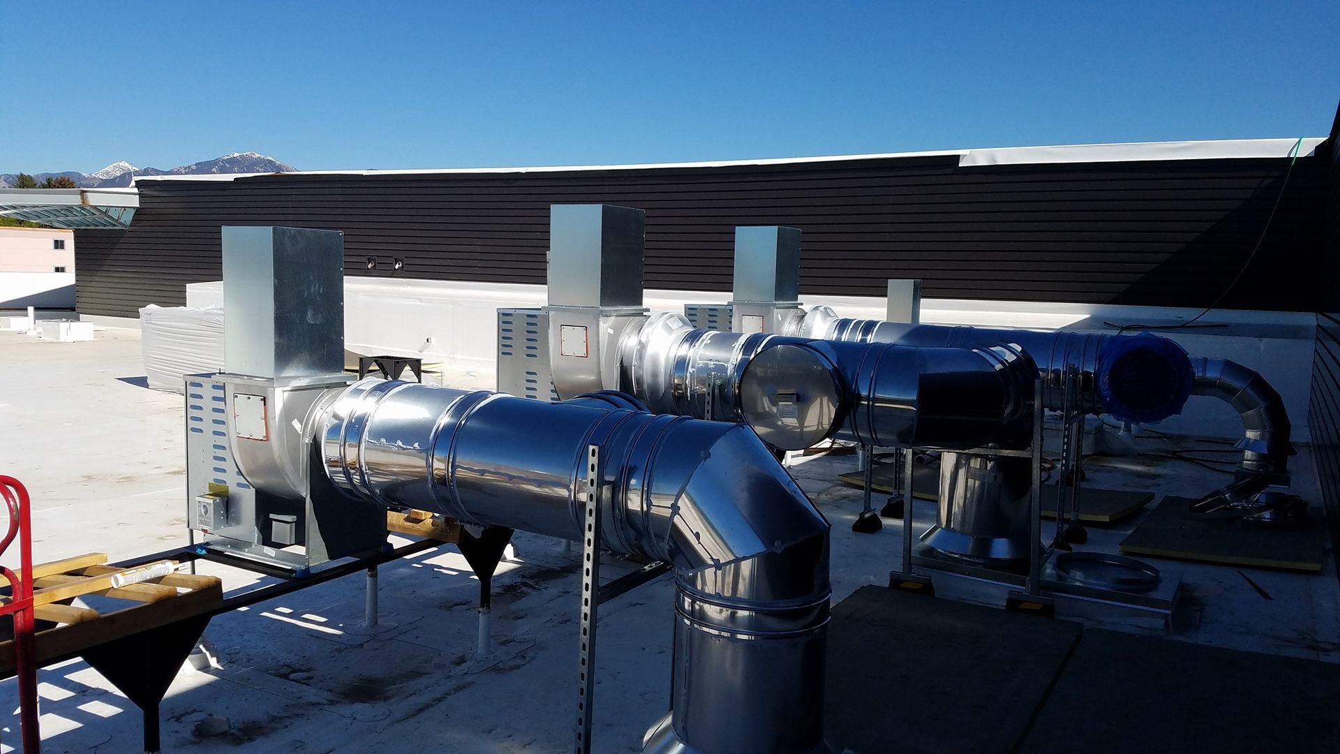 A bunch of pipes are lined up on a roof
