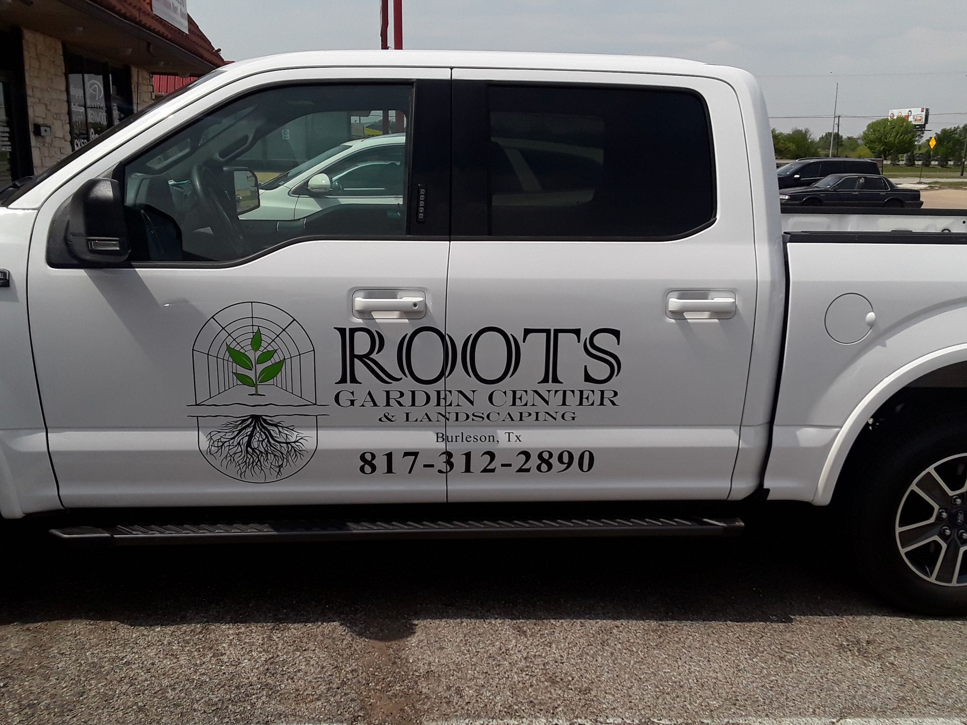 Black pickup truck with partial door and tailgate wrap
