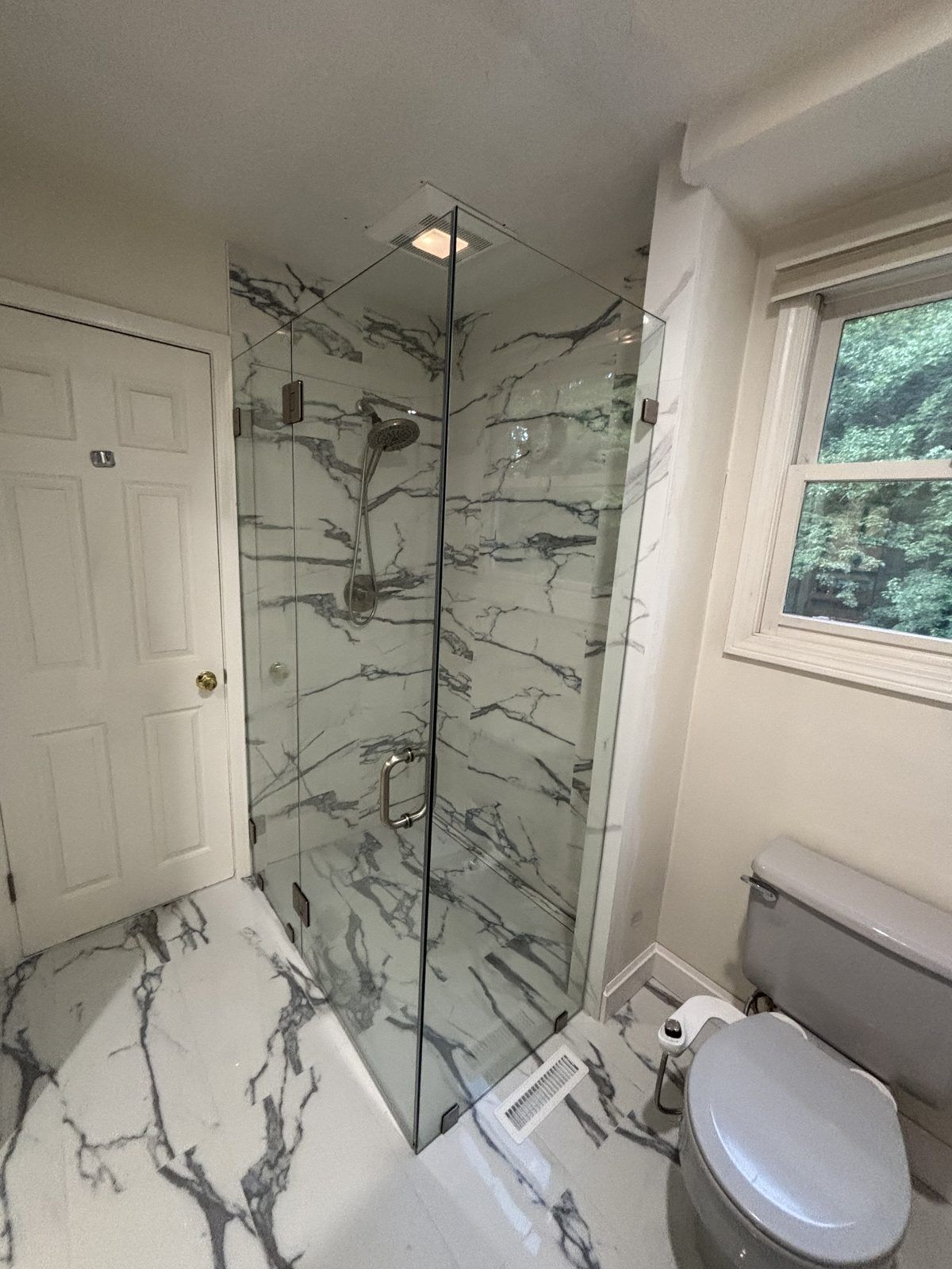 Frameless corner glass shower with marble tile walls, Plymouth, MA