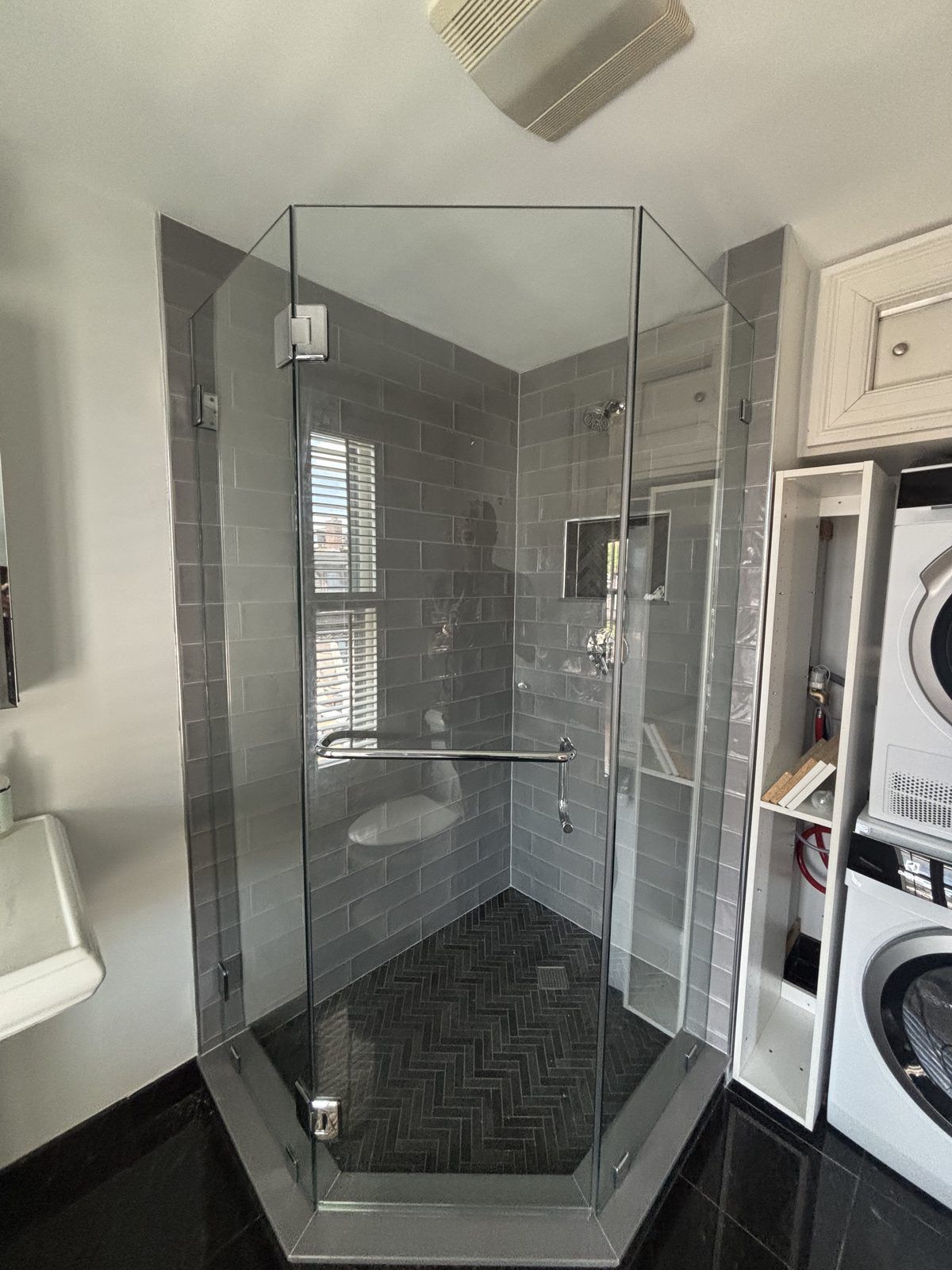 Neo-angle frameless shower enclosure with gray subway tile in a Marblehead, MA bathroom