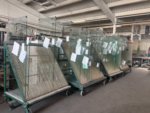 Racks of tempered glass panels at a glass fabrication facility