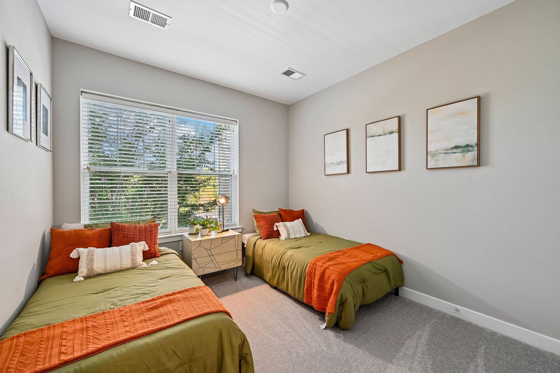 Bedroom with two twin beds and colorful bedding, ideal for roommates at The View at Mill Run in Owings Mills, MD.