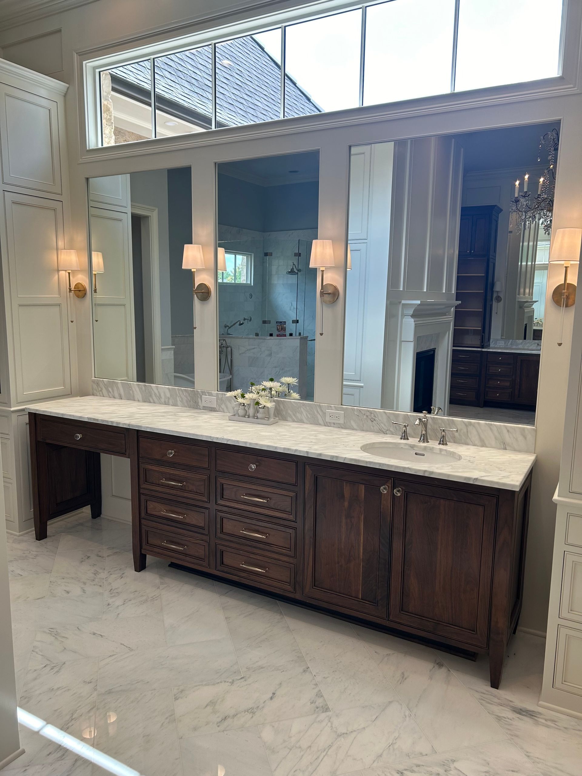 A bathroom with two sinks and a large mirror.
