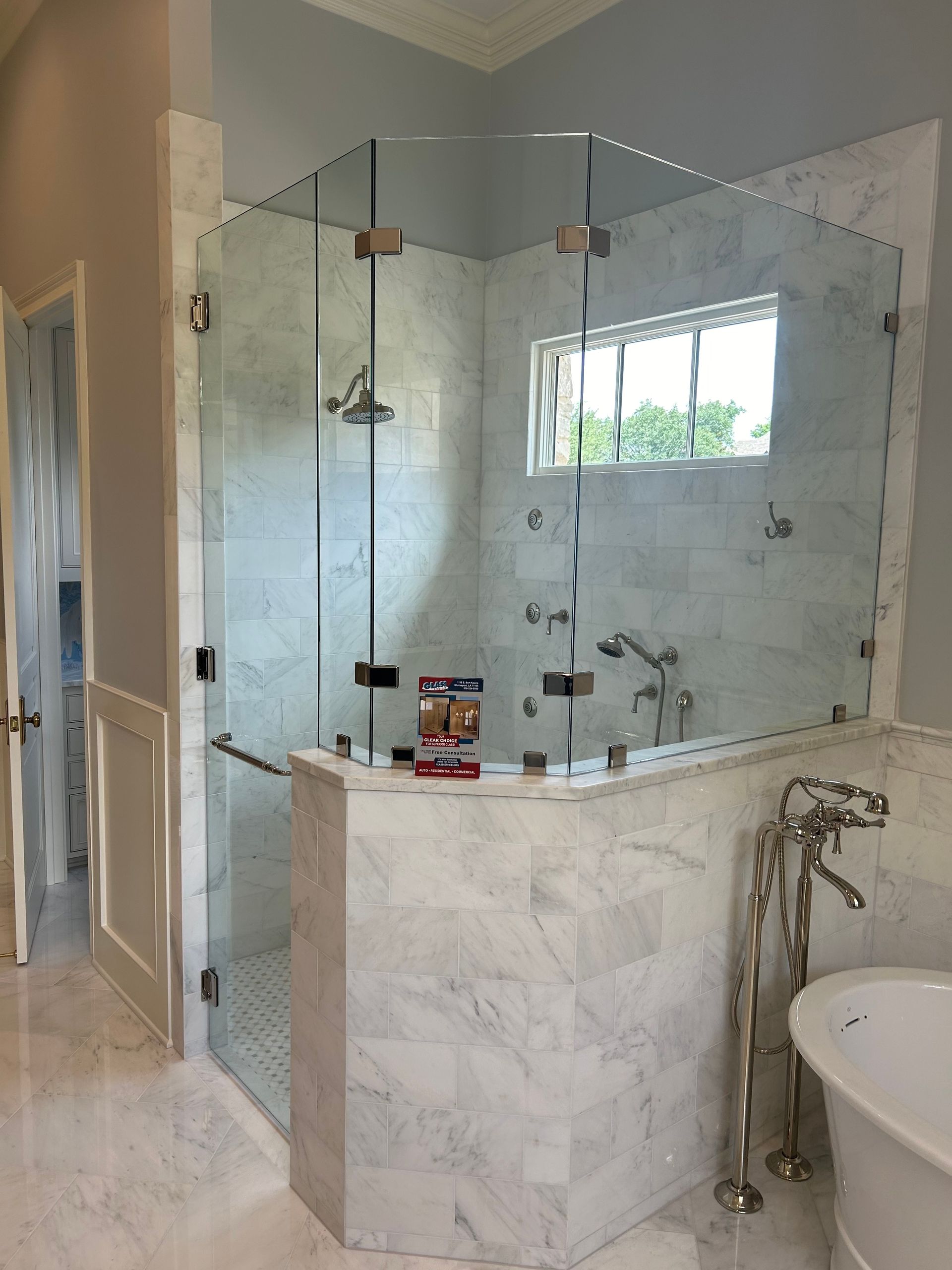 A bathroom with a walk in shower and a bathtub