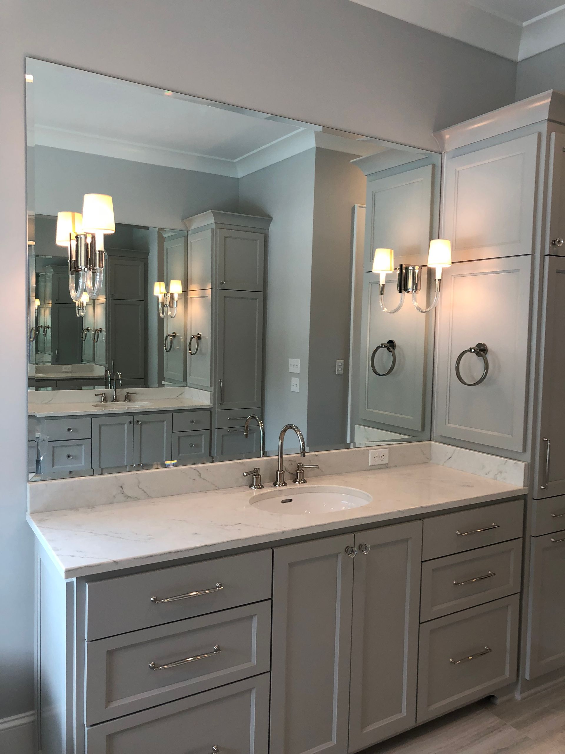 A bathroom with two sinks and a large mirror