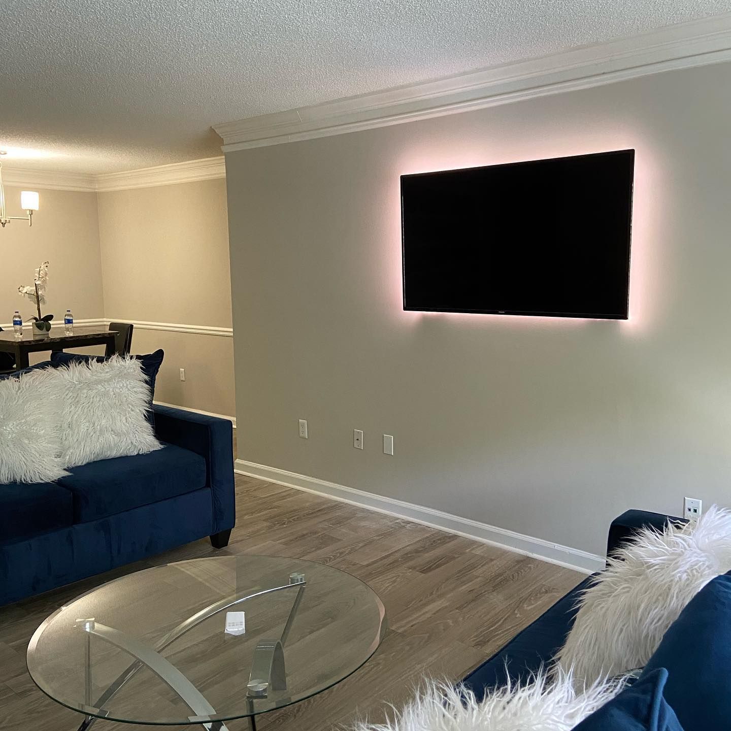 3Cs Audio-Visuals LLC | Home TV mounting service with pink ambient LED lighting and clean cable finish
