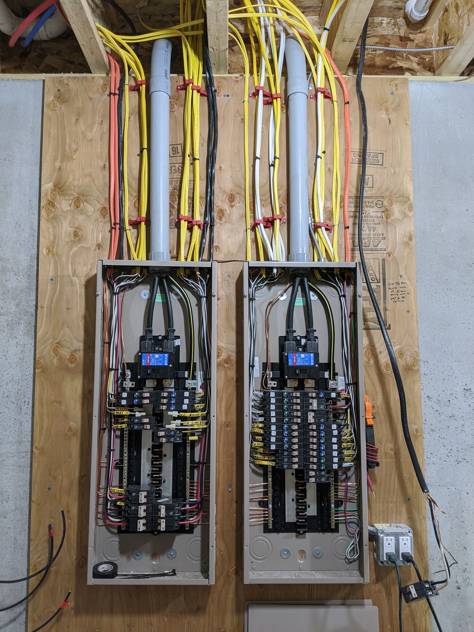 Two electrical boxes are sitting next to each other on a wooden floor.