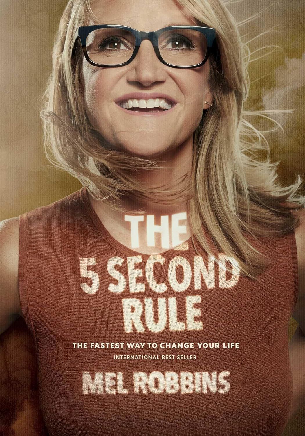 Book cover: Mel Robbins wearing glasses and a t-shirt with