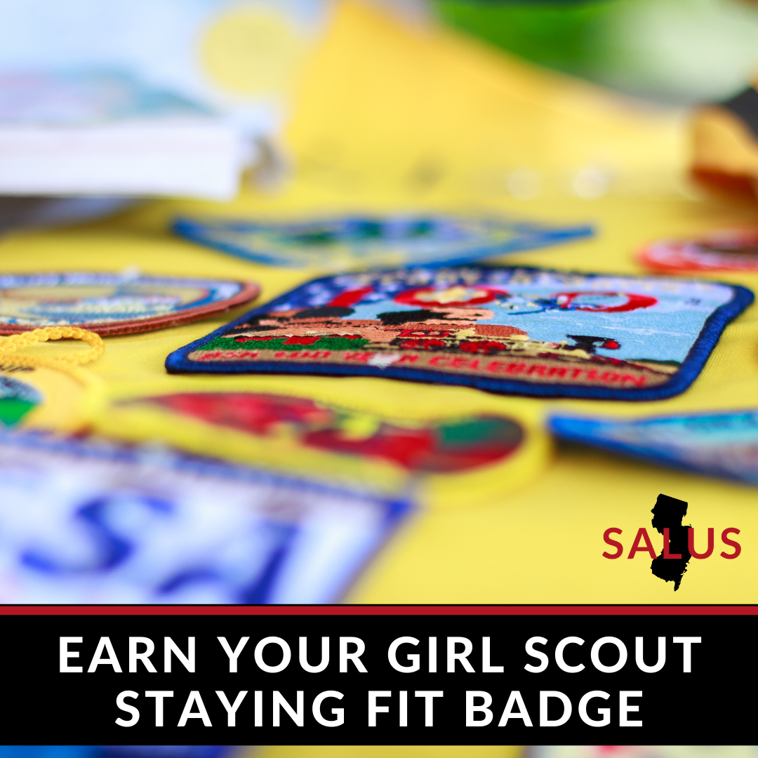 Girl Scout badges on a yellow surface, text says 
