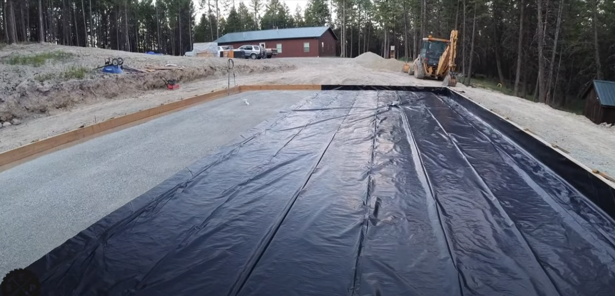 Garage foundation form with gravel and waterproof barrier
