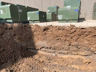 Ditch by utility boxes