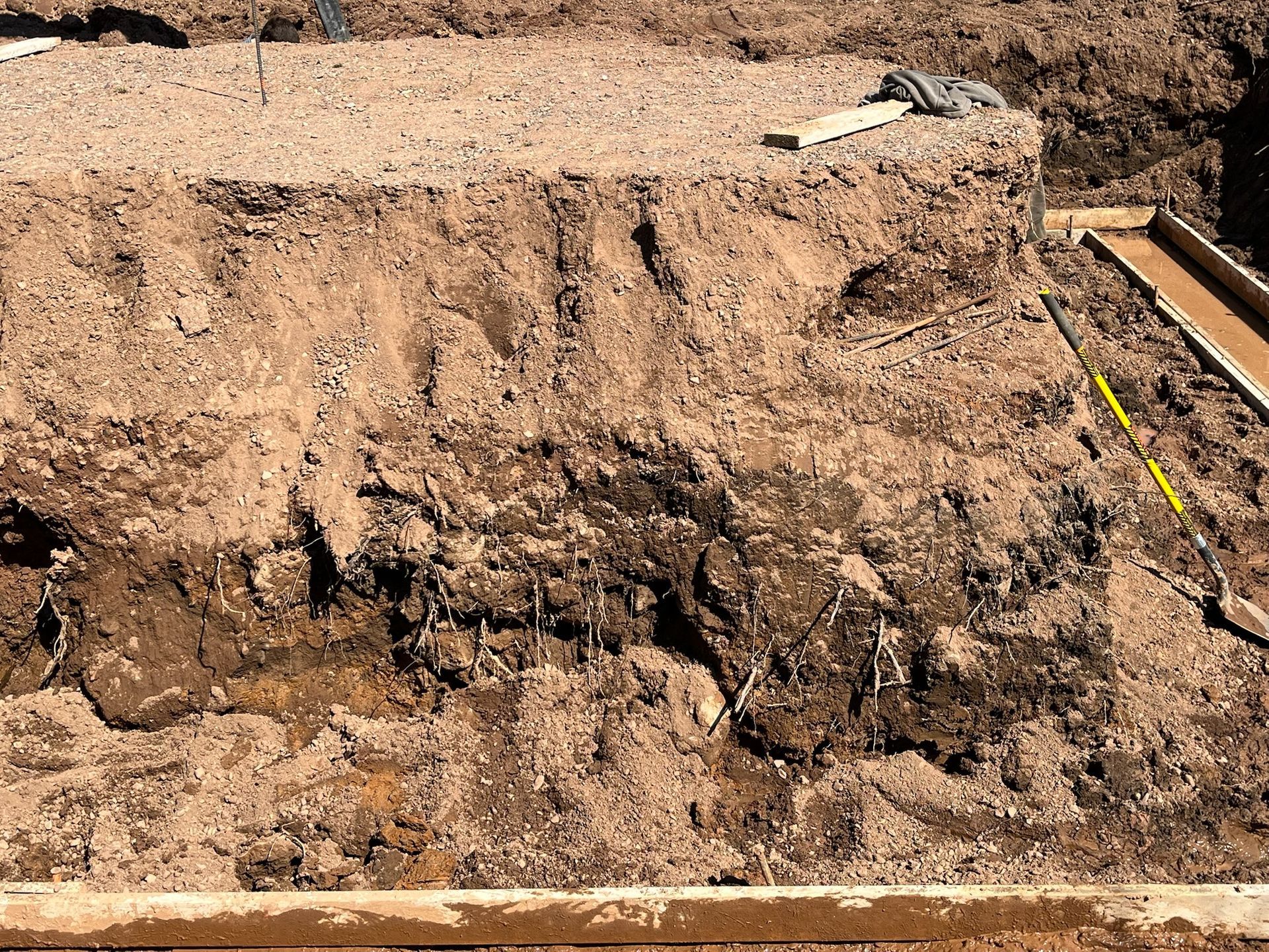 Section of earth showing layers of soil and gravel, possibly for a construction project.