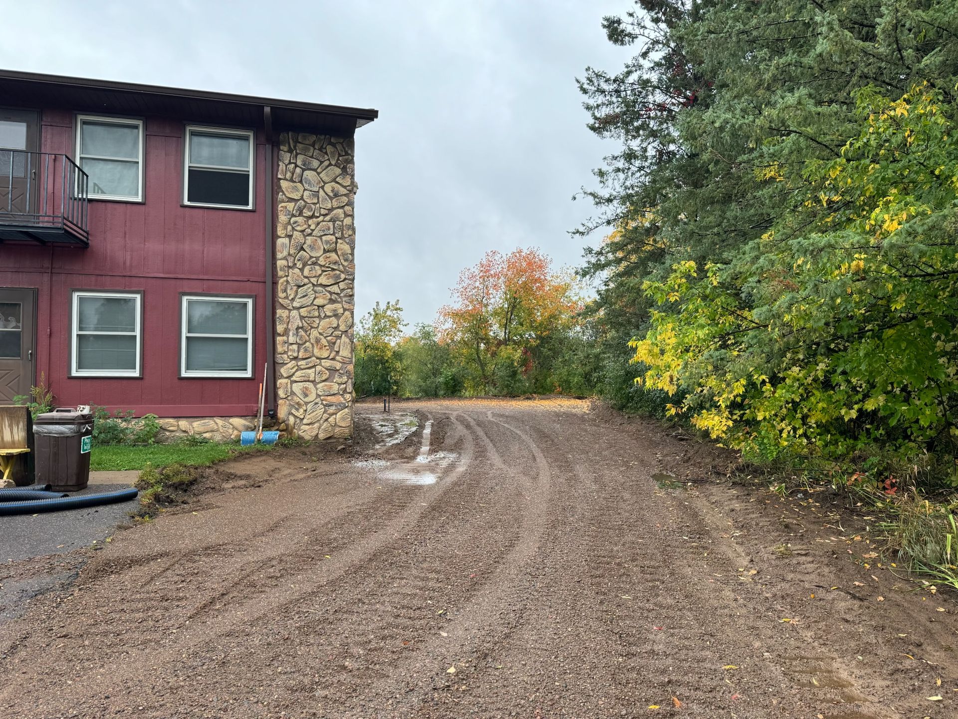 Dirt road next to red building