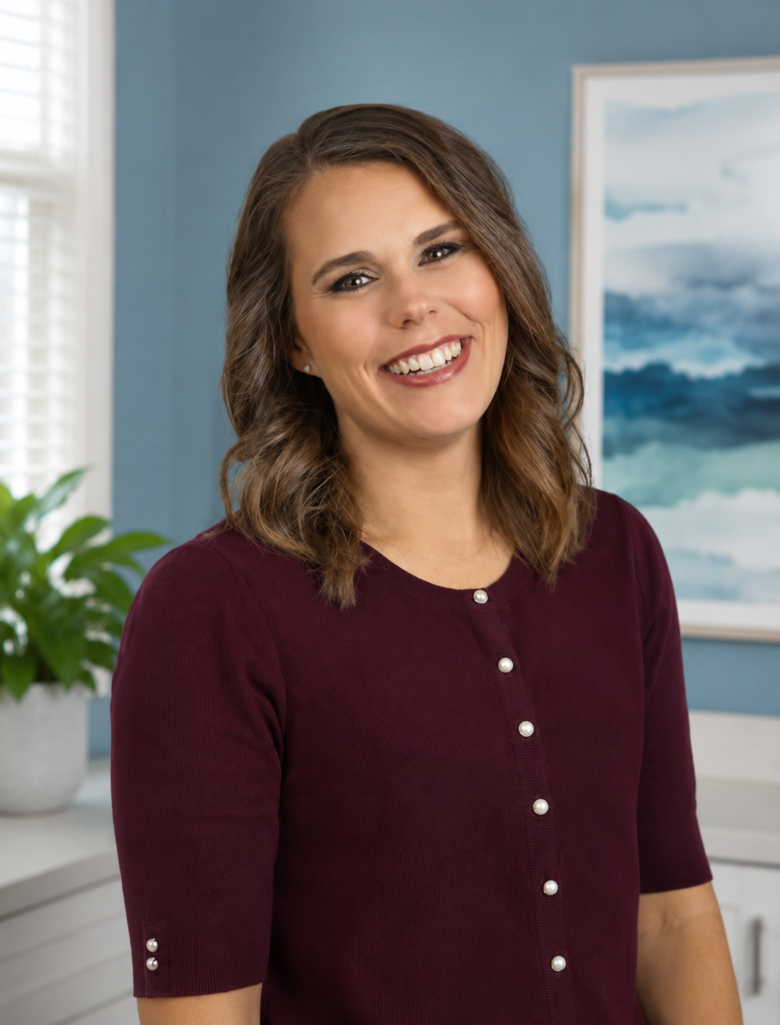 Smiling person in a black top in a bright office setting
