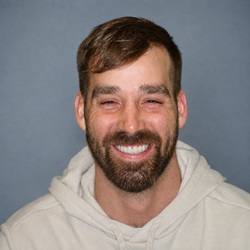 Man smiling after comprehensive cosmetic dental care by Dr. Harkin
