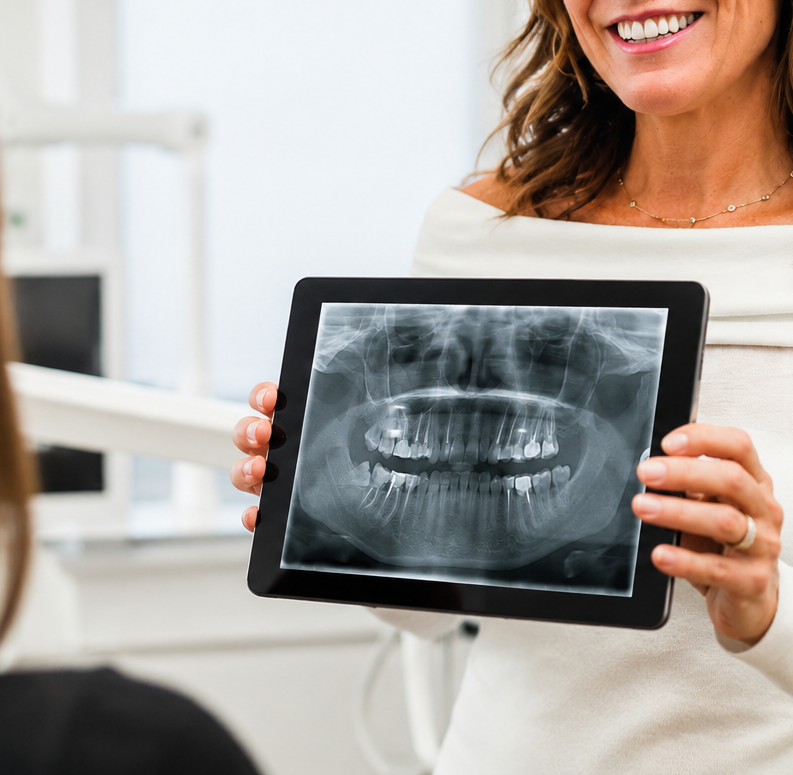 Dentist reviewing a patient x-ray