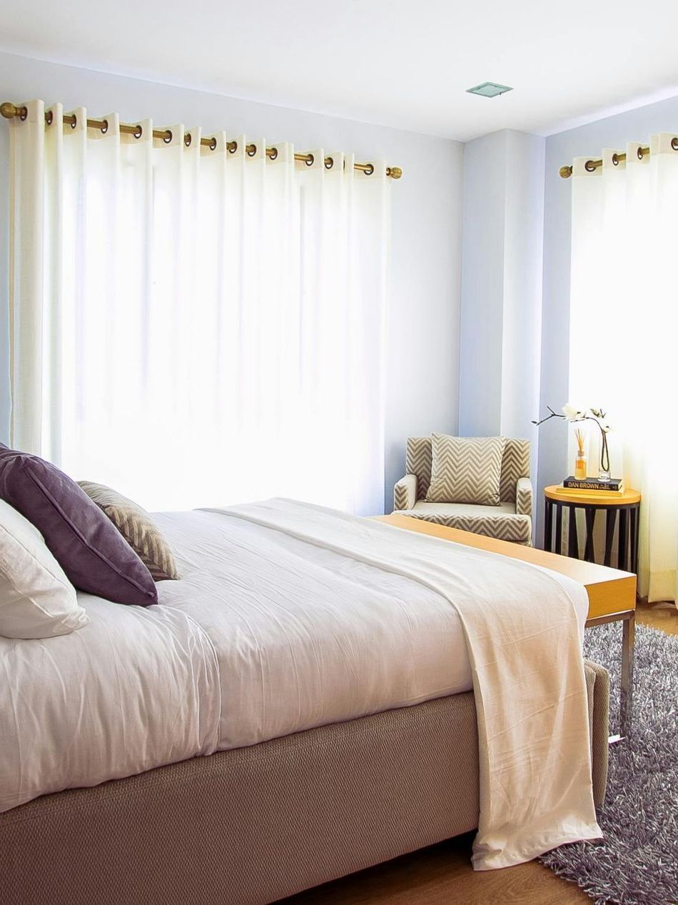 Lancaster pa pest control a bedroom with a bed , chair , table and window
