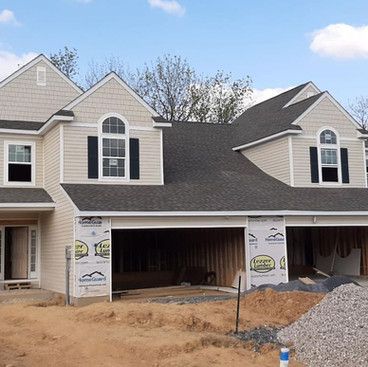 a house that is being built with a gray roof