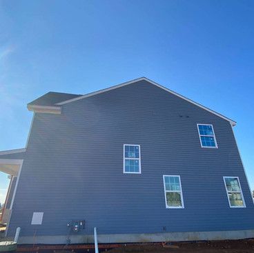 the side of a house with a blue sky in the background .