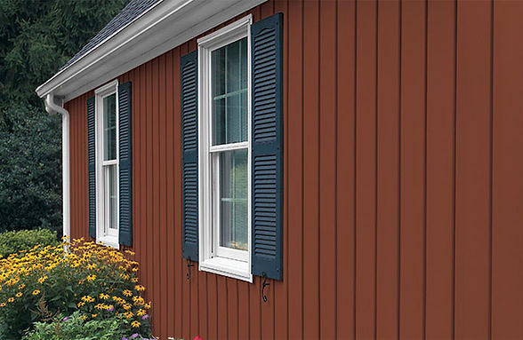 a red house with blue shutters and white windows .