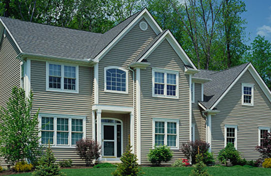 a large house with a lot of windows and a gray roof
