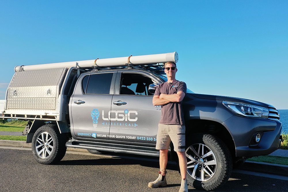 Logic Electrical owner, Michael Luic, in front of his truck that is branded