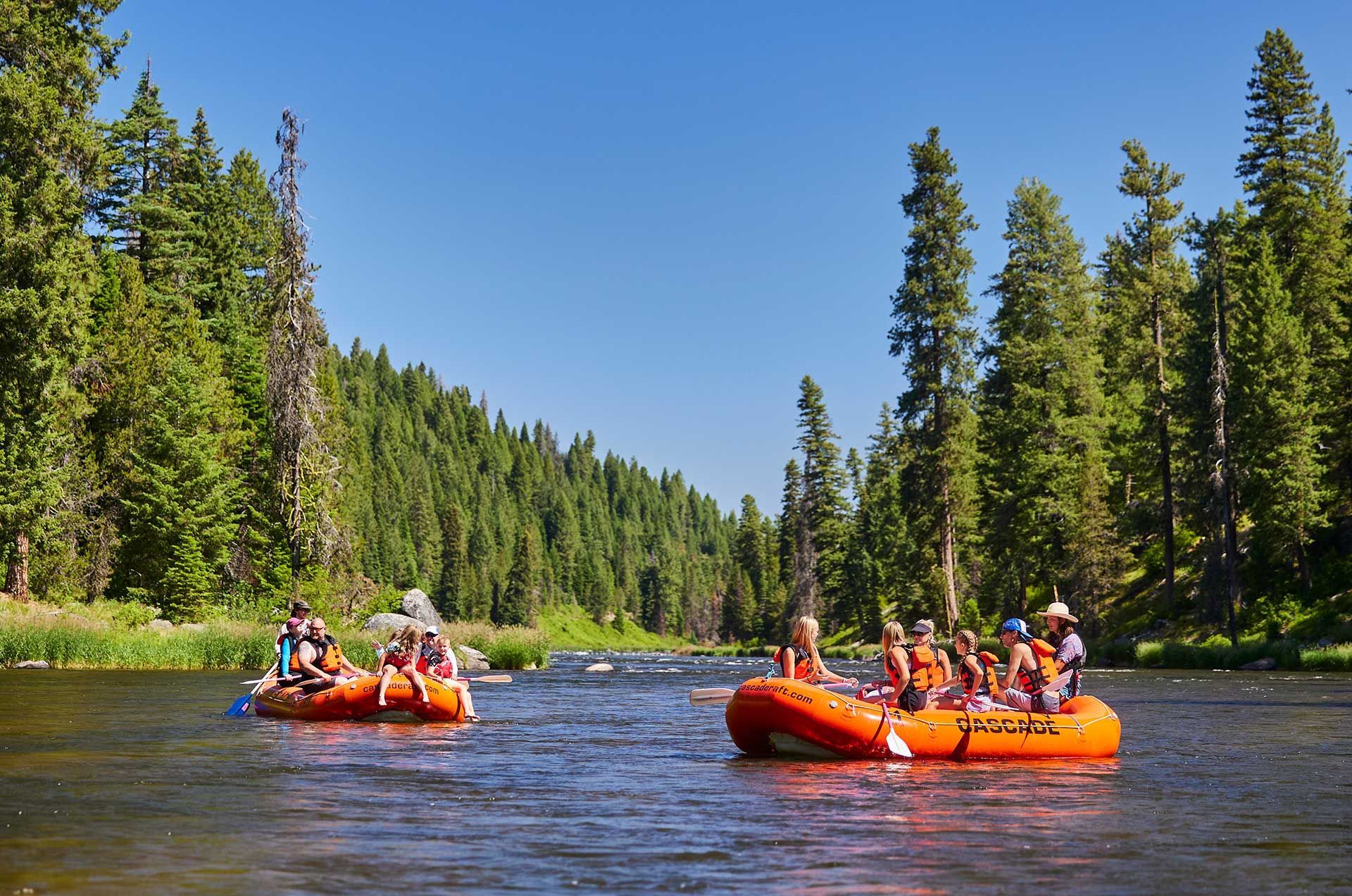 Family whitewater rafting through splashy Class II-III rapids on the North Fork of the Payette River near Boise, Idaho