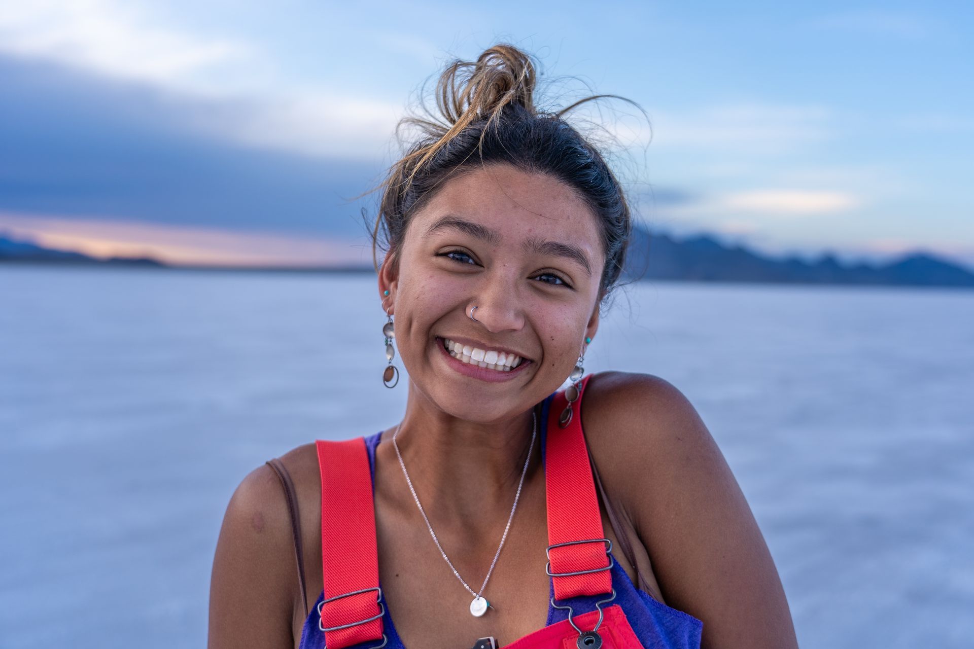 Staff member wearing a life jacket beside a lake