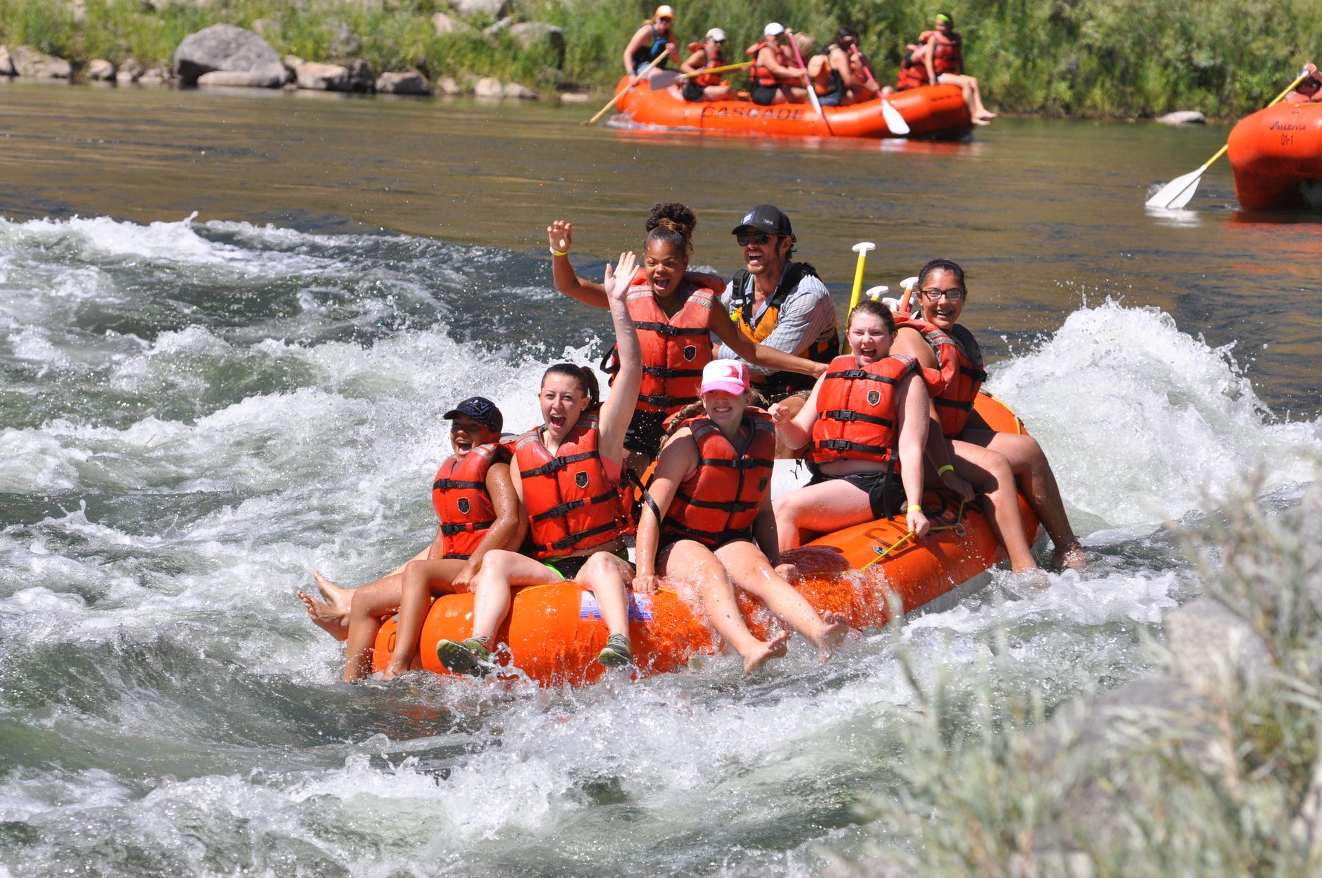 Family smiling while rafting in Idaho