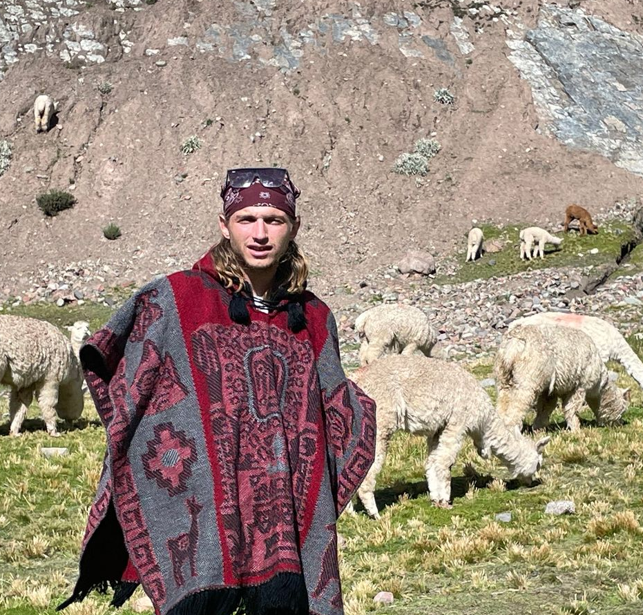 Staff member wearing a helmet in rocky terrain