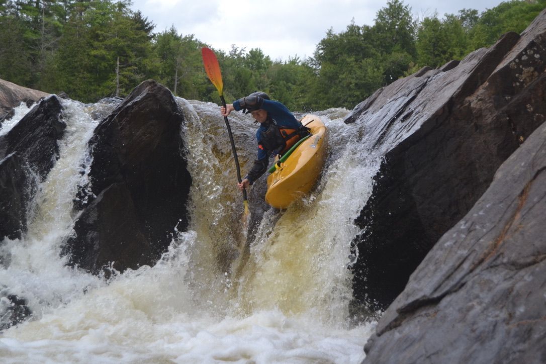 Kayaker descending a rocky waterfall