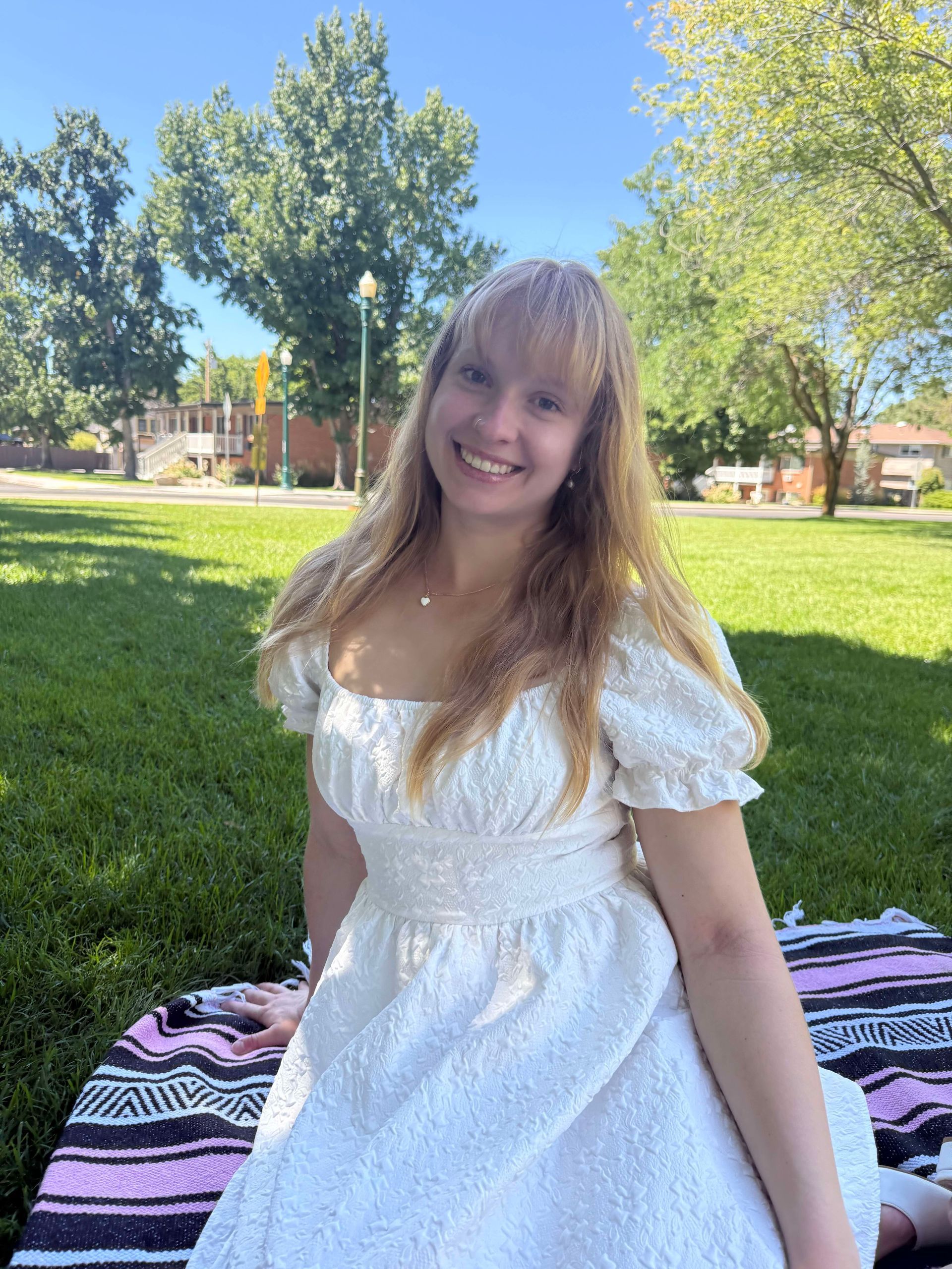 Staff member smiling in a park