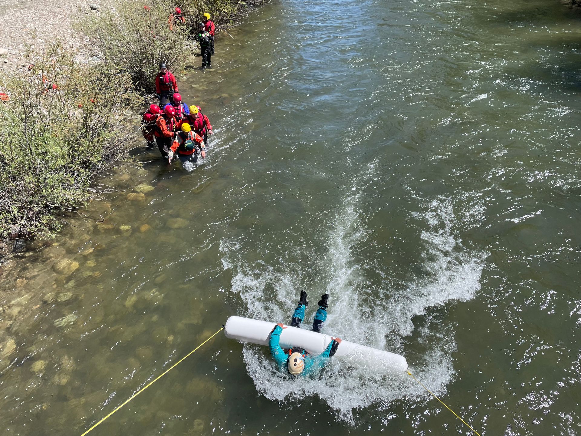 Overhead view of a river with people near the bank
