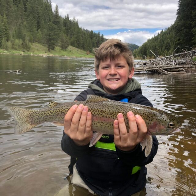 Staff member smiling beside a river