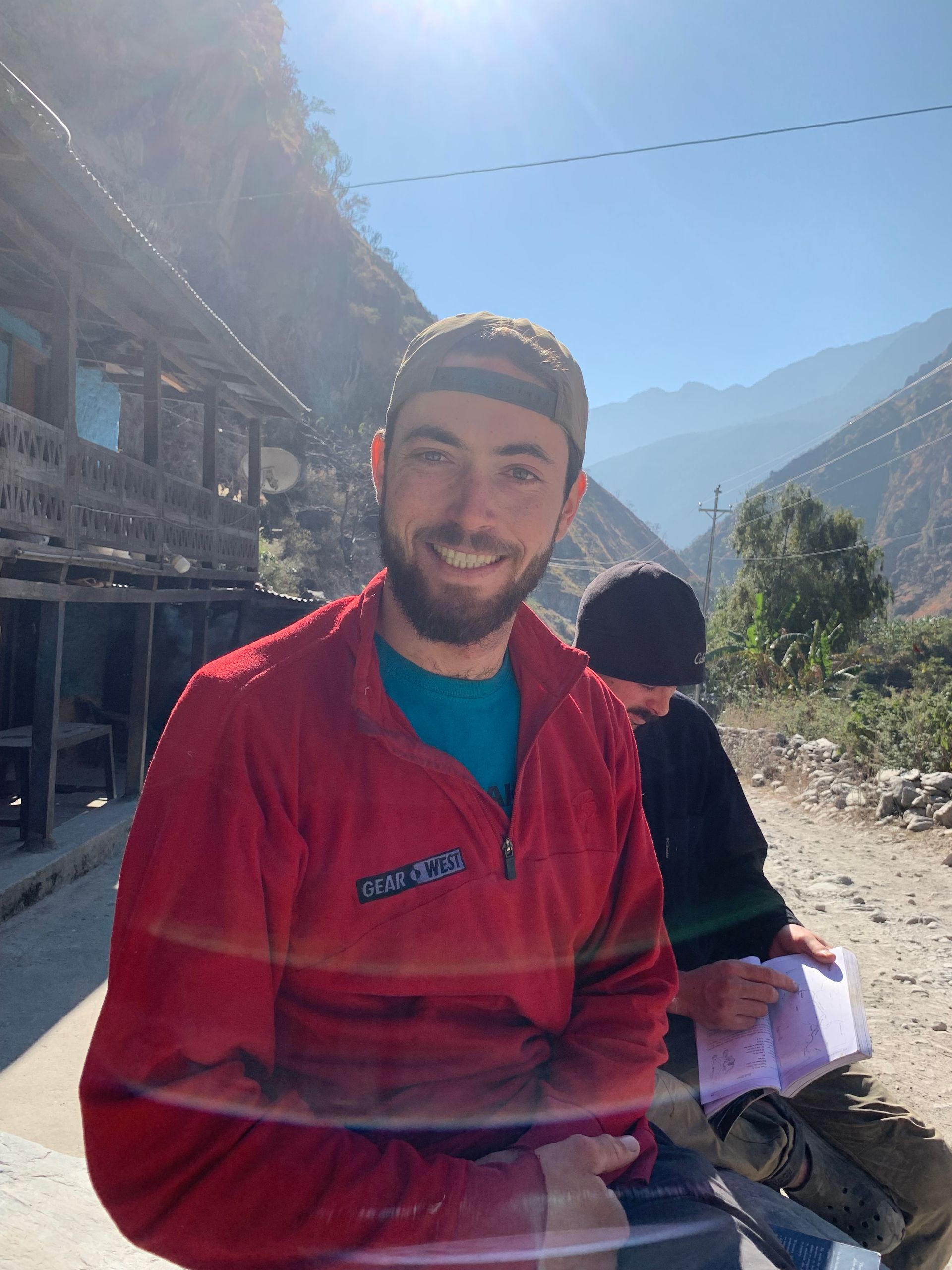 Helmeted staff member with mountains behind