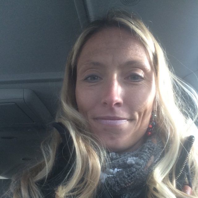 Staff member smiling inside a vehicle