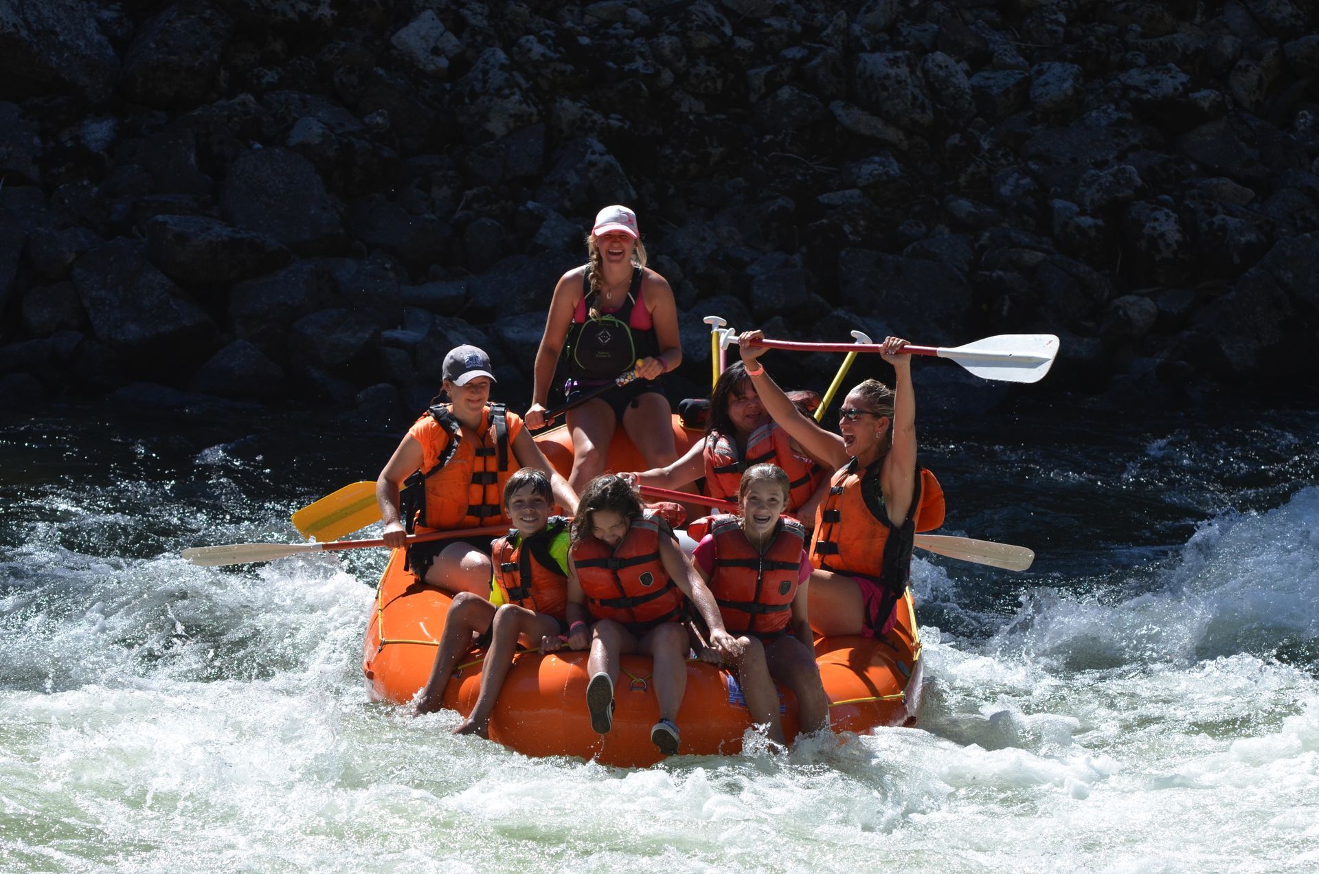 Family smiling while rafting on the Payette River.