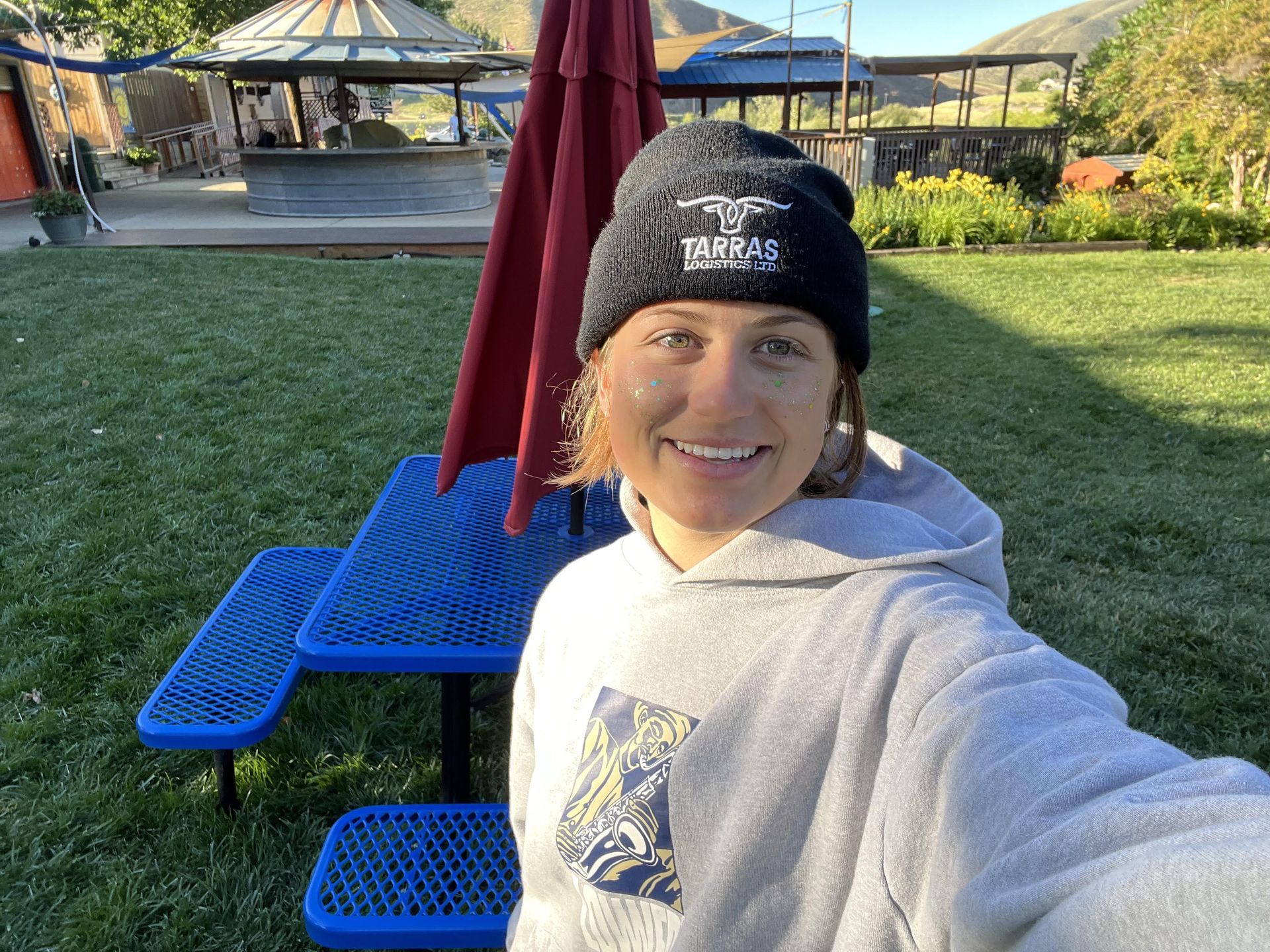 Staff member wearing a knit cap beside paddles