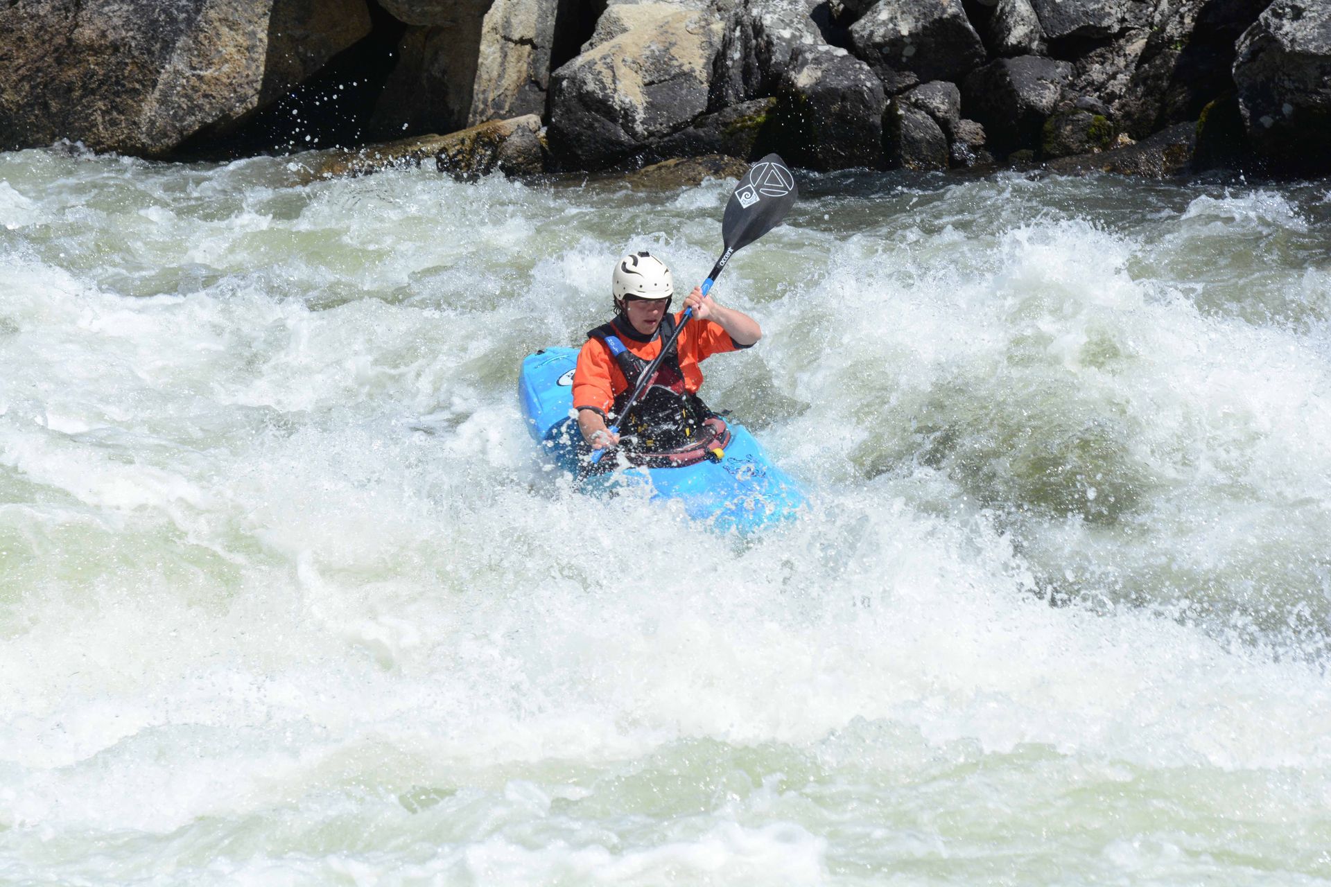 kayaker navigating a rapid