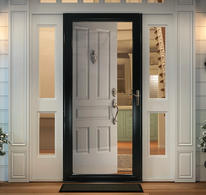 Open white front door with sidelights and glass panels at a home entrance