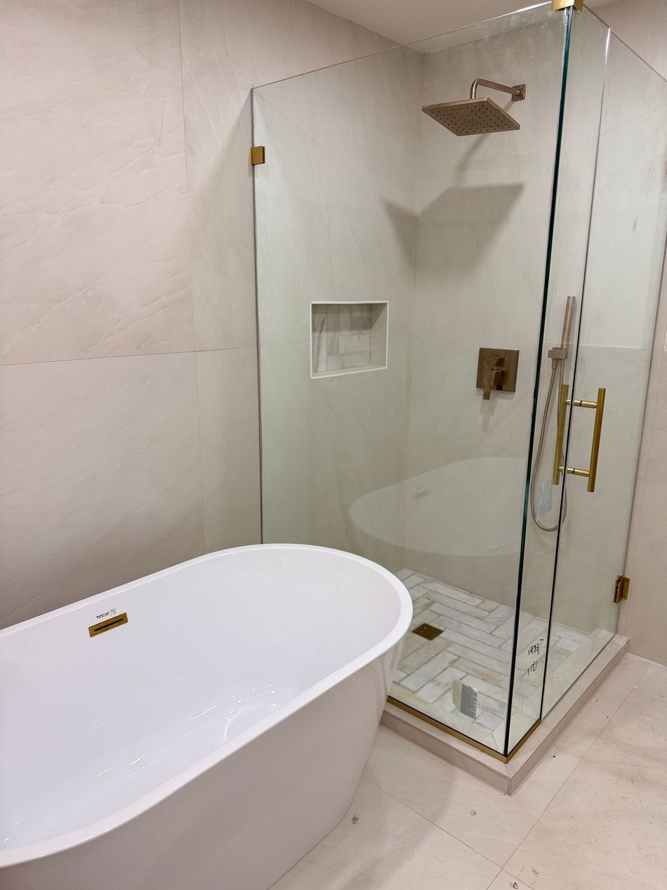 Modern bathroom with a freestanding tub and glass shower enclosure beside it