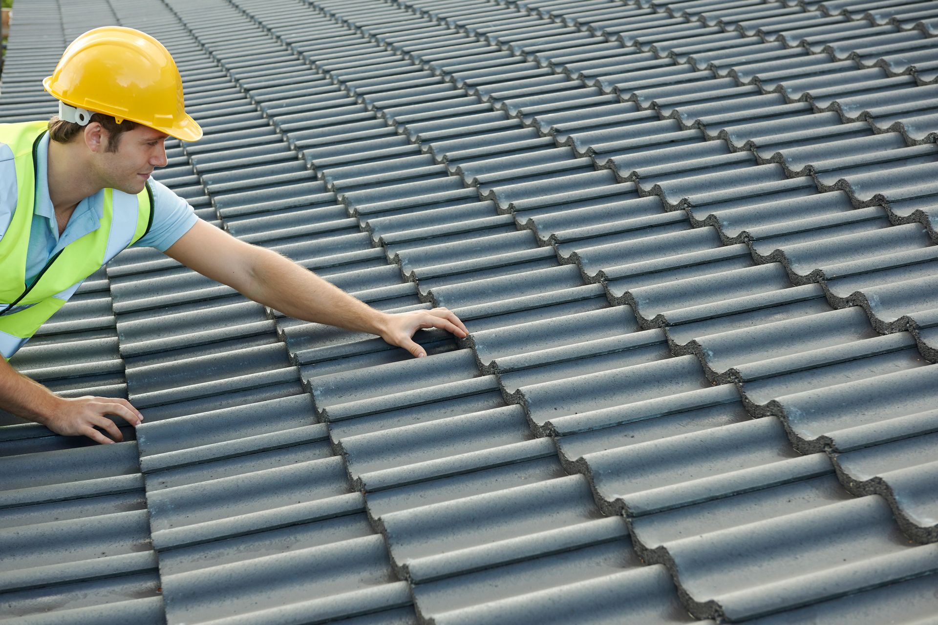 Skilled roofer at work on a commercial roof.