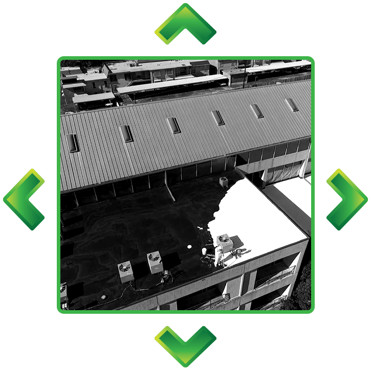An aerial view of a building with green arrows pointing up and down