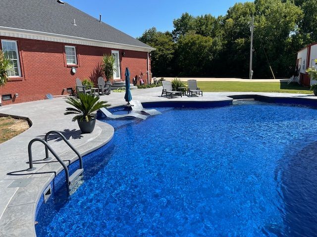 A backyard swimming pool with blue water.