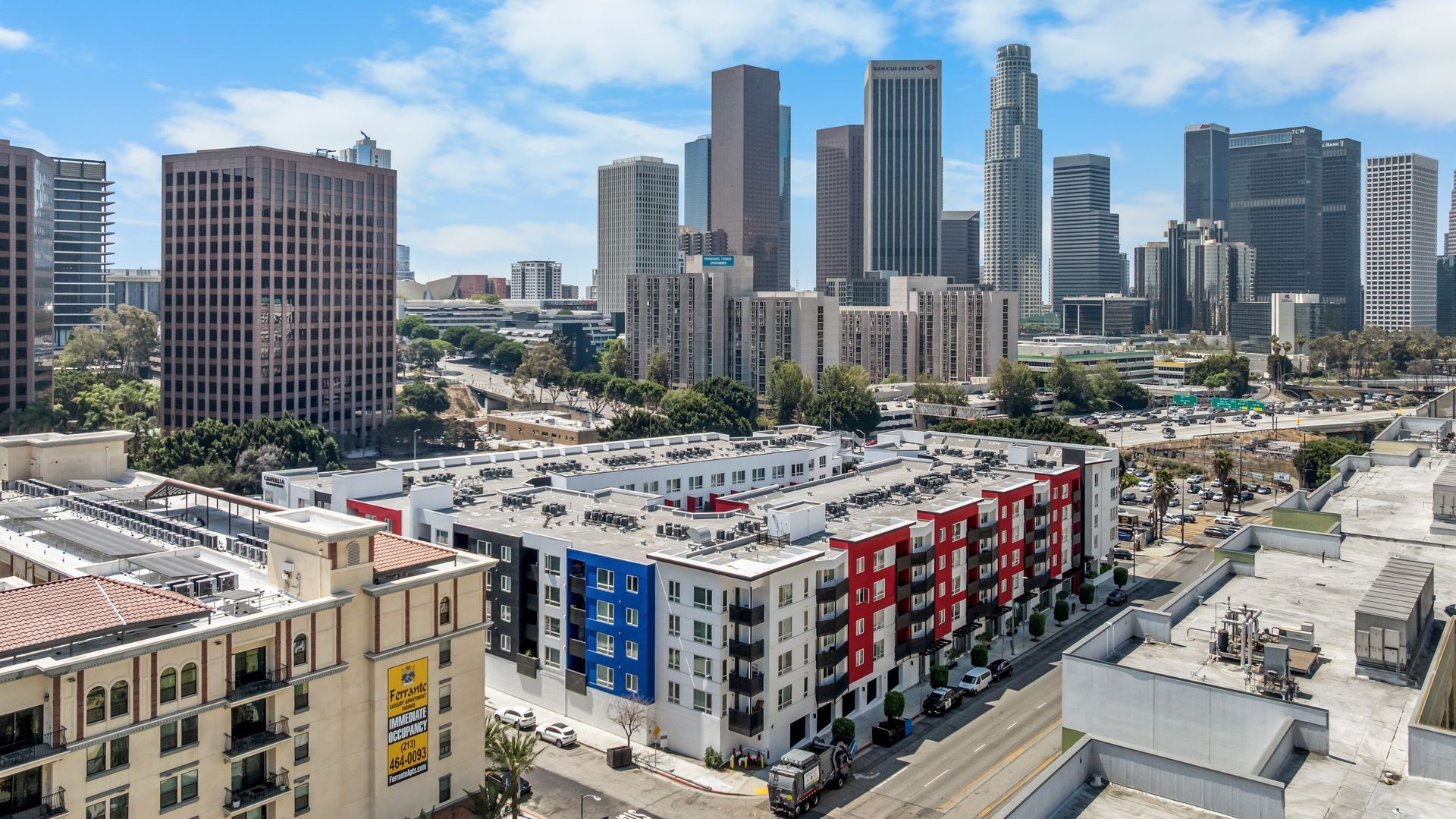 a multi story building with skyscrapers in the background