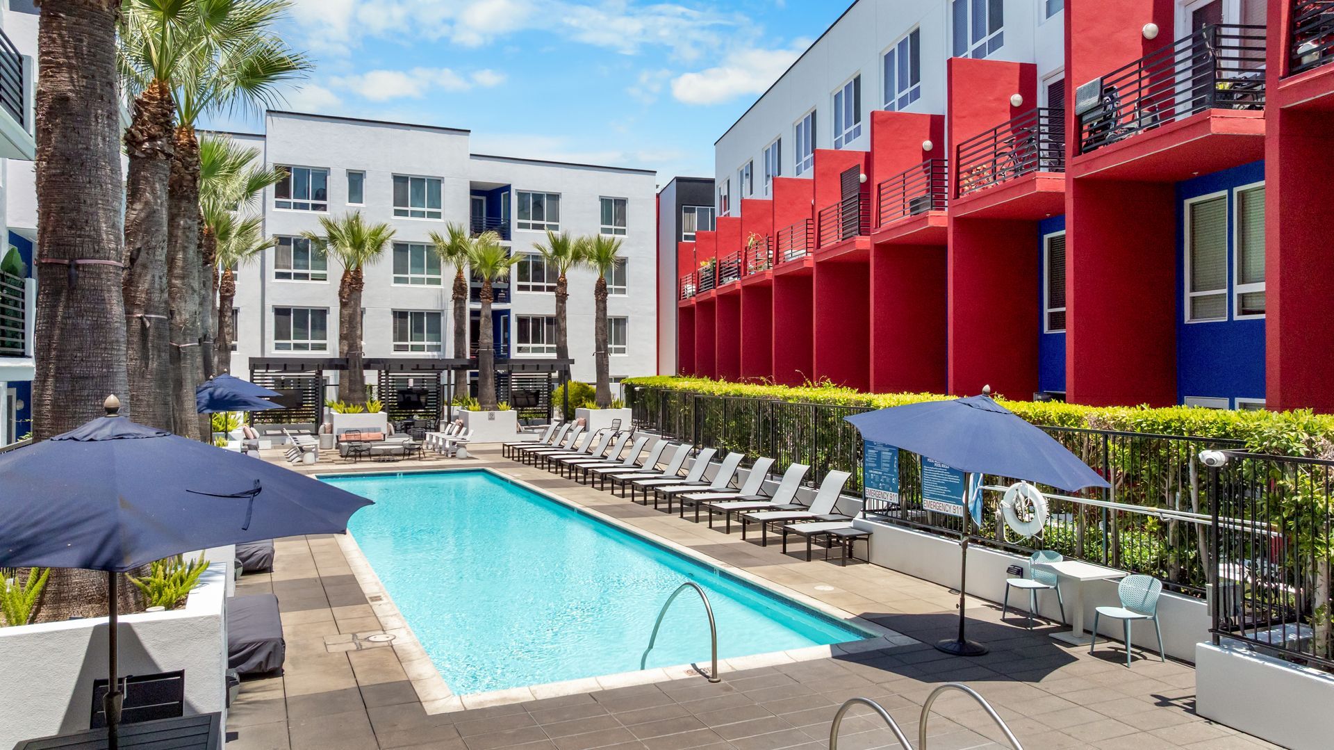 a swimming pool with lounge chairs 