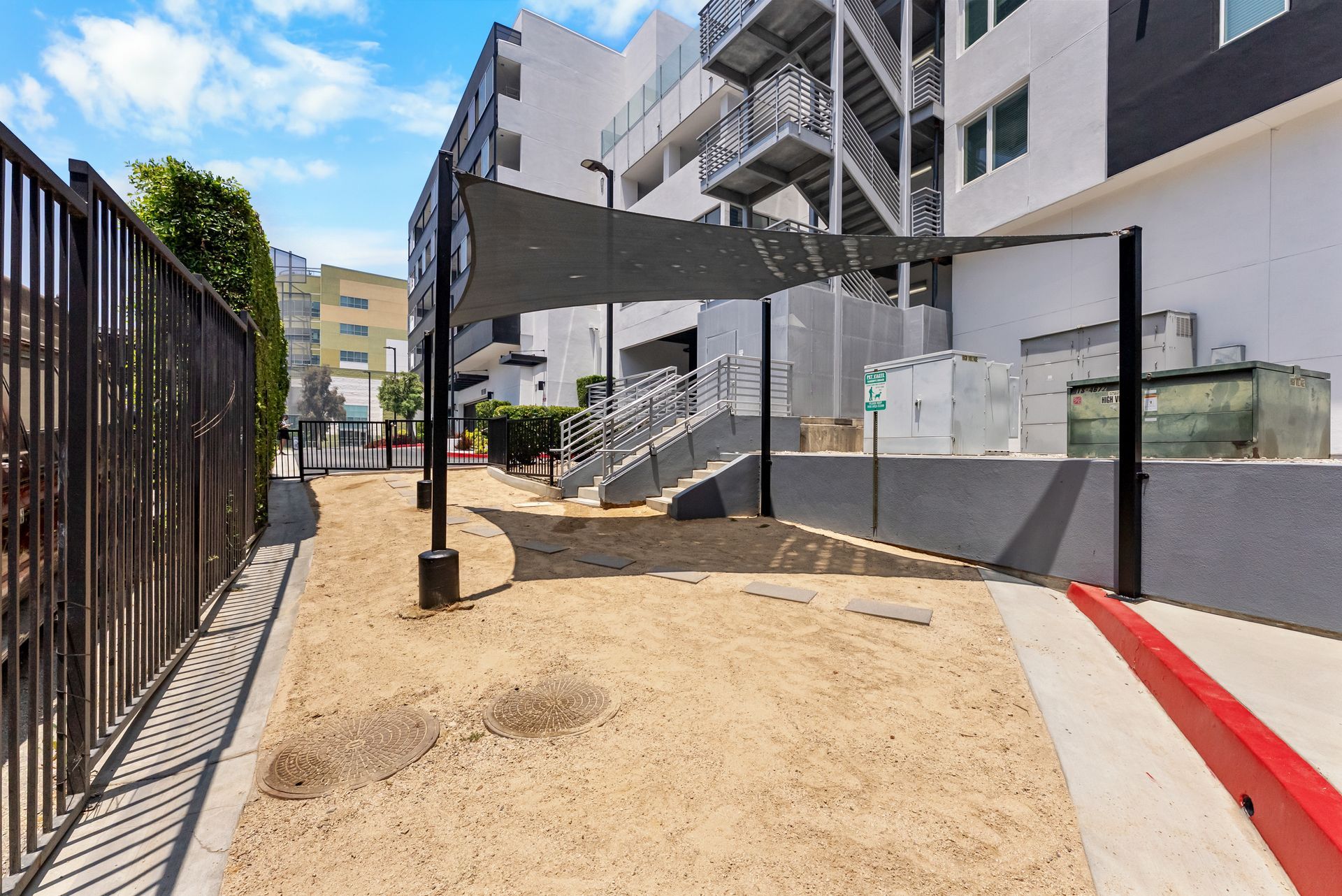 a gravel pet park covered by an awning