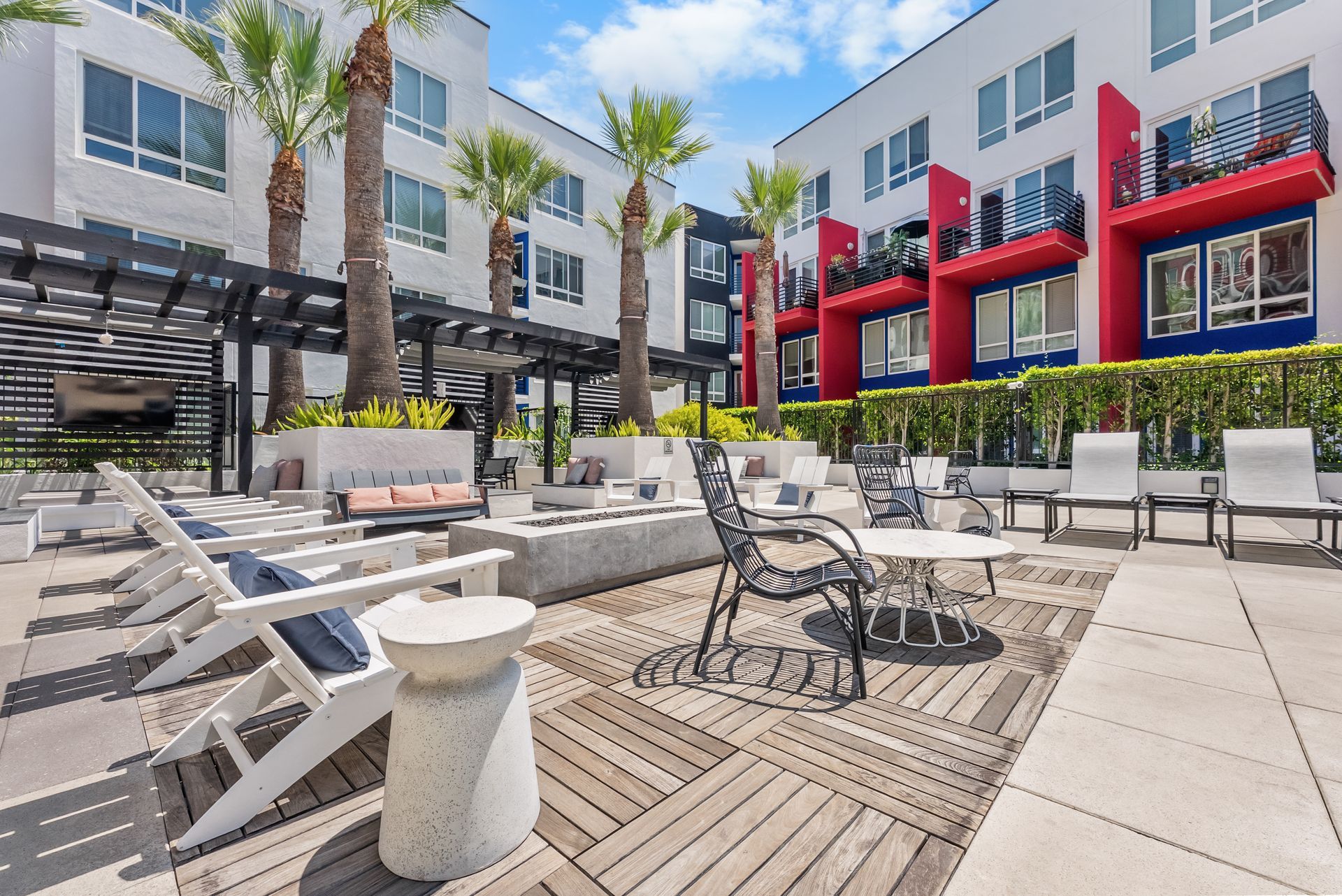 tables and chairs and a fire pit in a courtyard