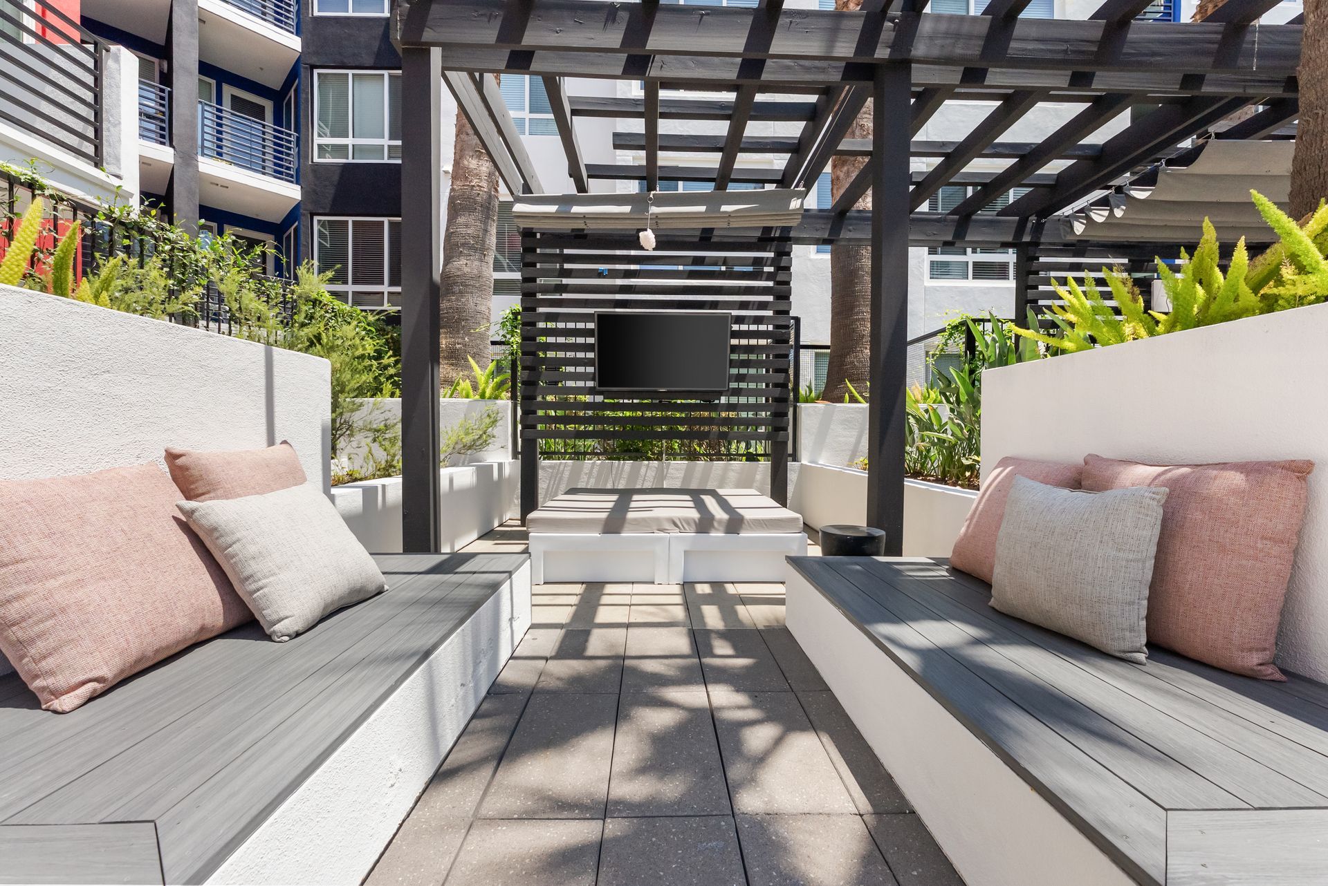 a covered seating area with a mounted television